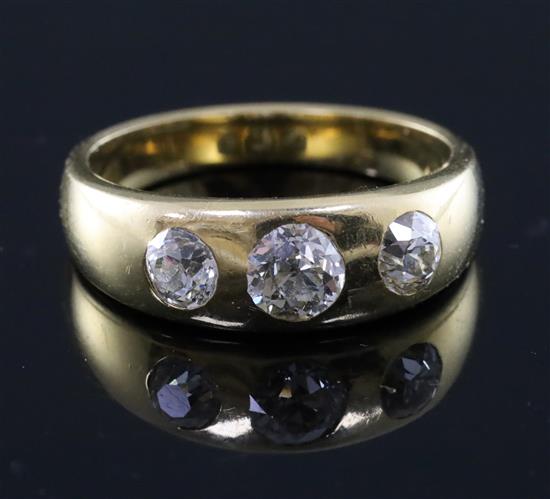 An 18ct gold and gypsy set three stone diamond ring, size N.